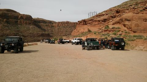 1979 Ford Bronco - A convoy of off-road vehicles takes a break in a scenic desert location.