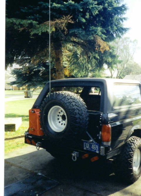 1988 Ford Bronco - Rear view of a 1988 Ford Bronco, showing the spare tire and bumper details. License plate EOL 469 is visible.