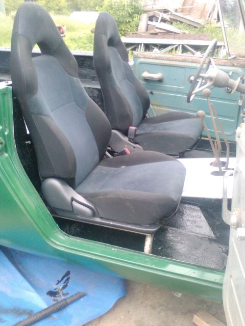 1991 Ford Bronco - Aftermarket bucket seats installed in a vehicle's interior.