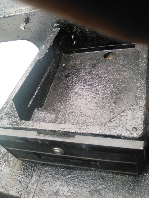 1991 Ford Bronco - A close-up view of a metal compartment, possibly from a vehicle's interior or exterior, with a visible latch mechanism.