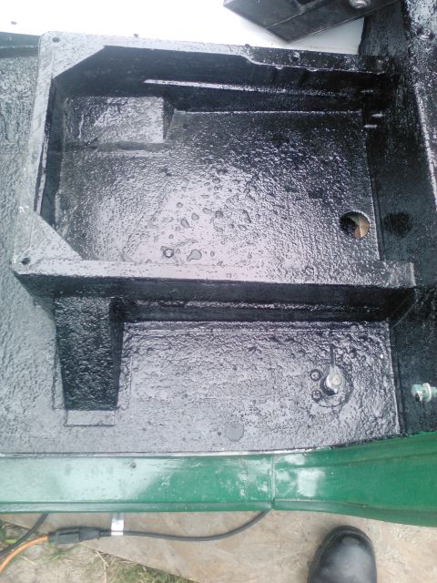 1991 Ford Bronco - Vehicle frame section showing undercoating and some green body paint.