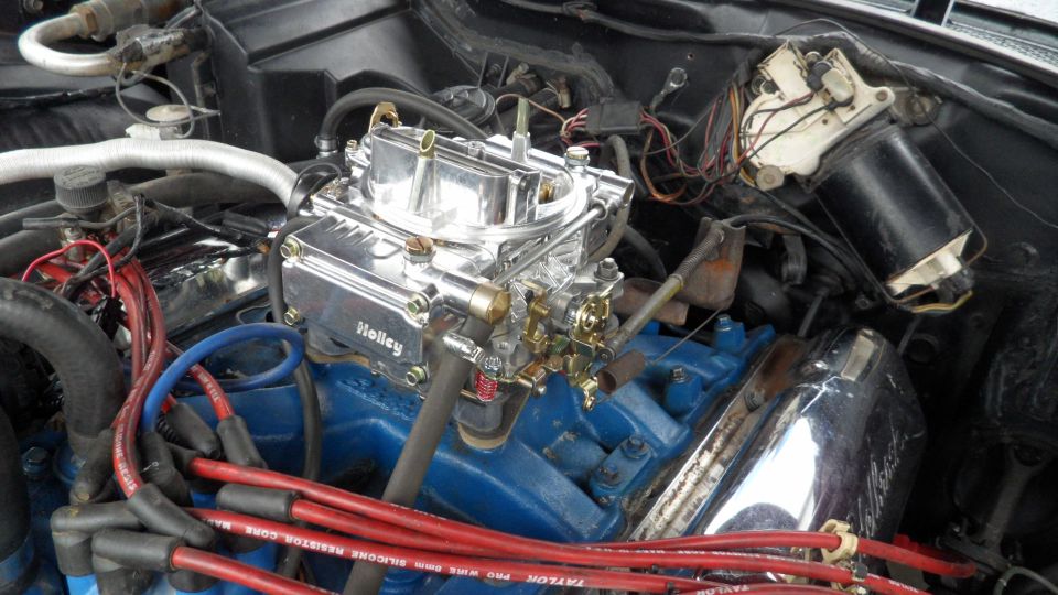 Engine bay with chrome Holley carburetor and blue engine block