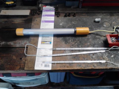 1990 Ford Bronco - Several fluorescent light tubes and associated wiring are laid out on a workbench, with packaging visible.