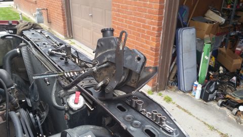 1981 Ford Bronco - Power steering pump assembly removed from vehicle, resting on engine bay components.