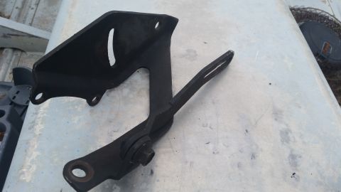1981 Ford Bronco - A black metal engine bracket is shown, likely a replacement part for a vehicle.