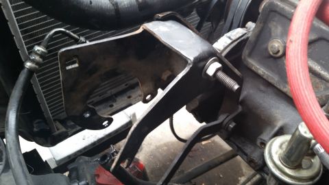 1981 Ford Bronco - Close-up view of a metal bracket attached to the engine and near the radiator.