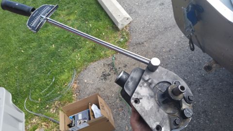 1981 Ford Bronco - A torque wrench is positioned over a metal component, with a cardboard box of supplies nearby.