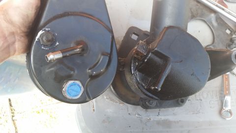 1981 Ford Bronco - Comparison of two power steering pumps, one is being held for inspection.