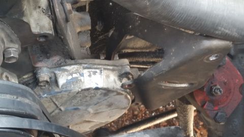 1981 Ford Bronco - Close-up view of an engine component and its mounting bracket.