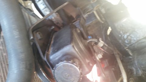 1981 Ford Bronco - Power steering fluid reservoir and associated hoses, likely from an older vehicle's engine bay.