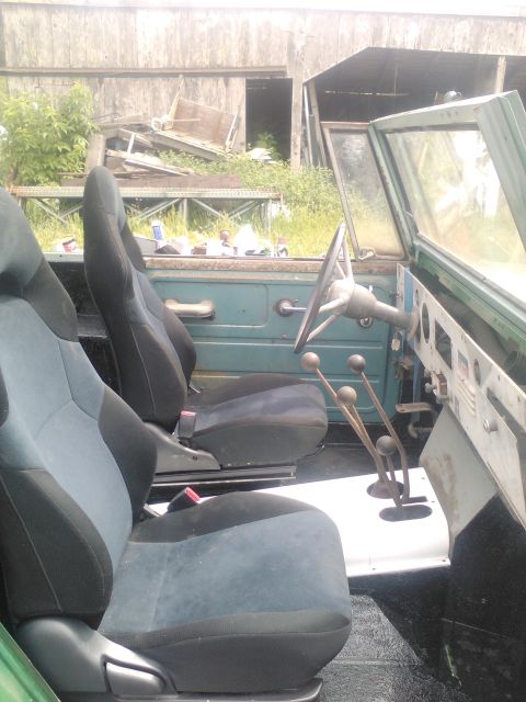 1991 Ford Bronco - Interior of an old off-road vehicle showing seats and manual transmission controls.