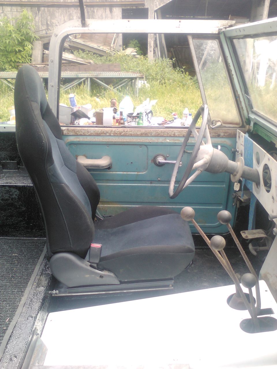 Interior view of a vintage SUV showing a bucket seat, dashboard, and gear shifters