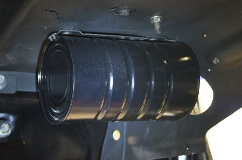 1979 Ford Bronco - A close-up view of an unidentified black cylindrical part attached to the undercarriage of a vehicle.