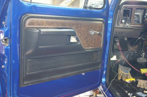 1979 Ford Bronco - Interior view of a 1979 Ford Bronco showing the door panel and exposed dashboard wiring.
