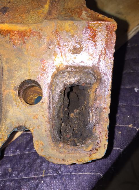 1978 Ford Bronco - This heavily corroded metal component shows significant rust and internal damage.