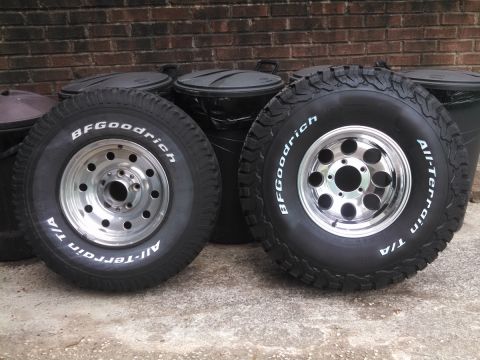 1995 Ford Bronco - Two BFGoodrich All-Terrain T/A tires mounted on chrome wheels are shown, likely for a truck or SUV.