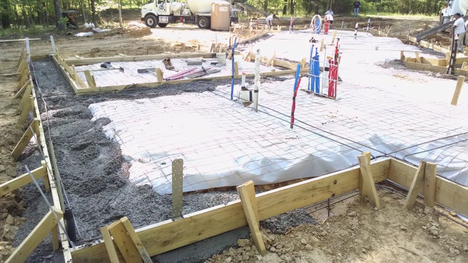 Between rain storms, the slab was poured.