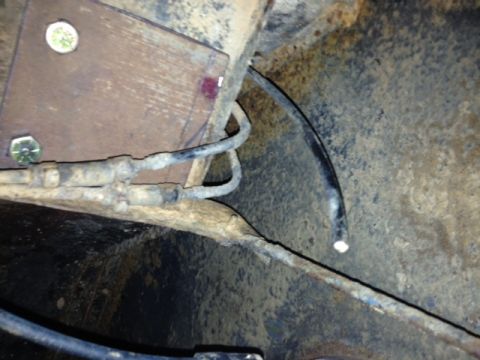 1973 Ford Bronco - Underside view of brake lines and mounting hardware on a vehicle.