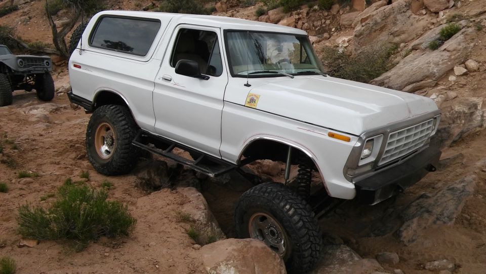 White 1979 Ford Bronco navigating rocky terrain