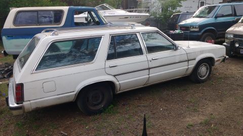 1980 Ford Fairmont - A white 1980 Ford Fairmont station wagon is parked outdoors with other vehicles visible.