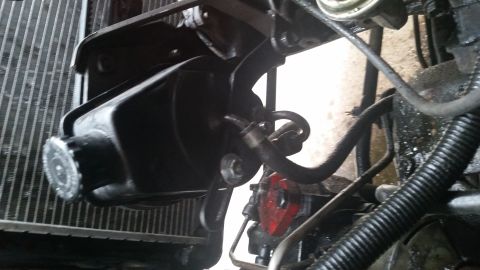 1981 Ford Bronco - Close-up view of a vehicle's power steering pump and reservoir assembly.