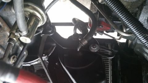 1981 Ford Bronco - Underside view of engine bay parts, including hoses and metal brackets, with a radiator visible.