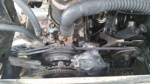 1981 Ford Bronco - Close-up view of an engine bay, showing the fan, belts, and pulleys.