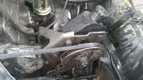 1981 Ford Bronco - Close-up view of the power steering pump and associated components within an engine bay.