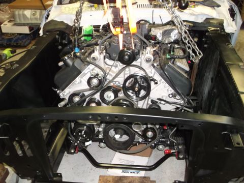 1967 Ford Mustang - Engine installation in progress, showing the complex mechanical components.