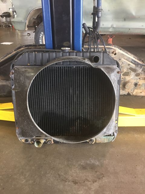 1978 Ford Bronco - Radiator assembly shown on a lift in a workshop setting.