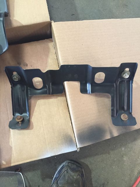 1978 Ford Bronco - A black metal bracket with visible bolts is shown, likely a vehicle part.