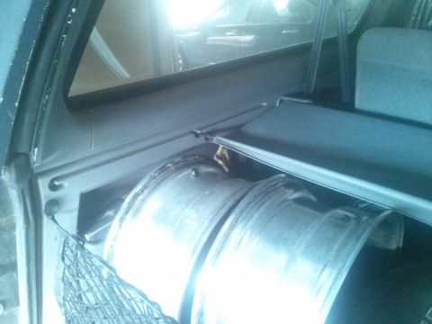 1995 Ford Bronco - Two spare tires are stored in the cargo area of this vehicle, covered by a retractable shade.