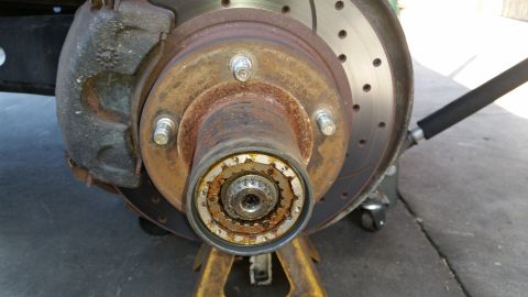 1992 Ford Bronco - Close-up of a 1992 Ford Bronco's front wheel hub and brake assembly, showing wear and tear.