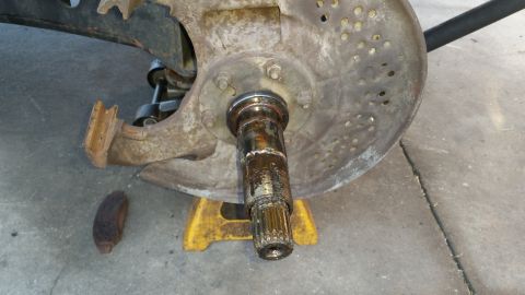 1992 Ford Bronco - The wheel hub assembly is heavily corroded and appears to be undergoing maintenance or repair.