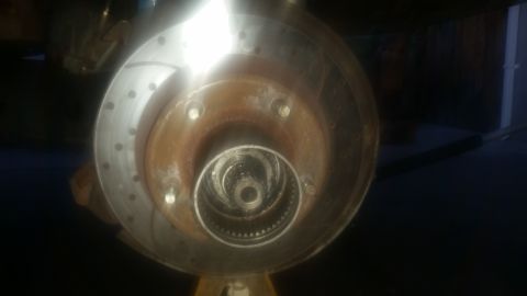 1992 Ford Bronco - Close-up view of a vehicle's wheel hub and brake rotor assembly.