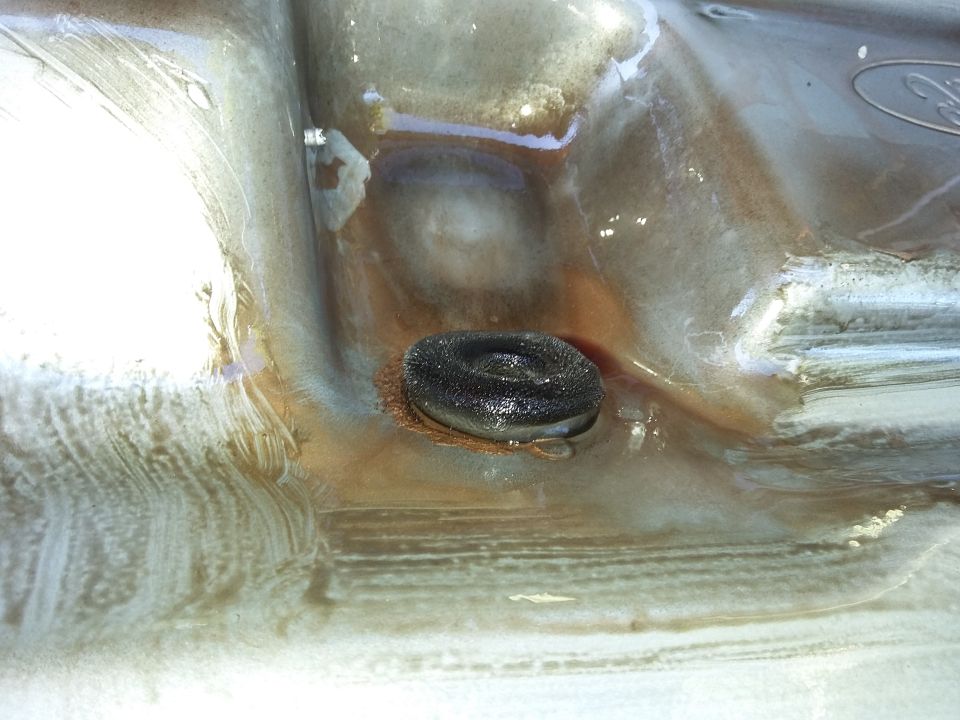 Ford emblem on a dirty, wet surface