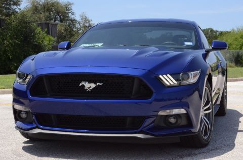2015 Ford Mustang - Front view of a blue Ford Mustang, showing the grille and headlights.