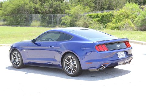 2015 Ford Mustang - This blue 2015 Ford Mustang GT coupe is shown from the rear three-quarter angle.