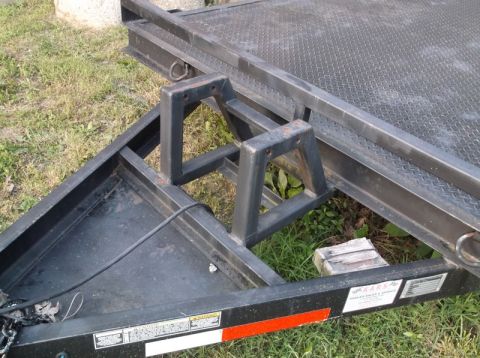2005 Ford F-150 - Trailer frame with welded metal wheel chocks, part of a larger trailer assembly.