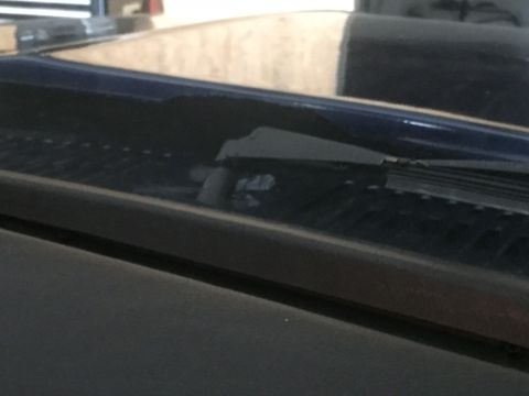 1982 Ford Bronco - Detail shot of the windshield wiper and cowl area of a vehicle.