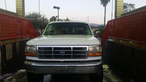 1992 Ford Bronco - Front view of a 1992 Ford Bronco being washed.
