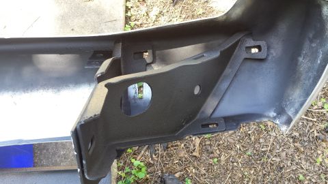 1976 Ford Ranchero - Close-up of a vehicle's rear bumper mounting bracket, showing its internal structure.