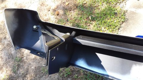 1976 Ford Ranchero - Close-up view of a vehicle's rear bumper assembly, showing its mounting hardware and construction.