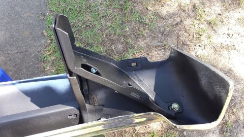 1976 Ford Ranchero - A disassembled rear bumper assembly for a Ford Ranchero is shown, with visible chrome trim and black metal mounting brackets.