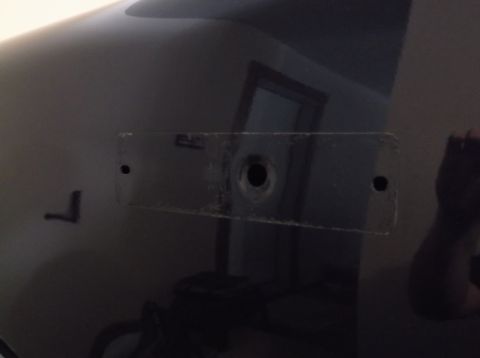 2005 Ford F-150 - This photo shows a section of a vehicle's body with holes for mounting a plate or emblem.