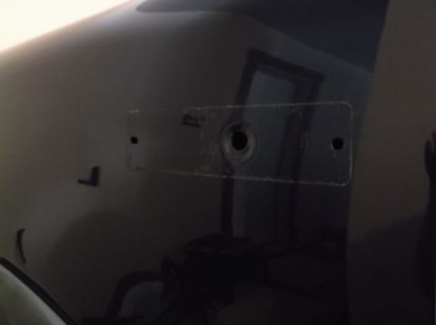 2005 Ford F-150 - A close-up of a dark vehicle panel shows evidence of removed trim or a mounting bracket.