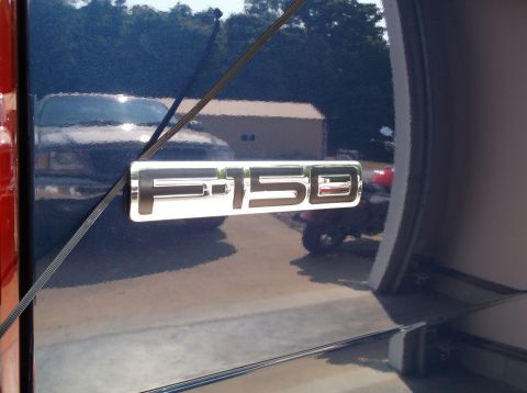 2005 Ford F-150 - Close-up of the F-150 emblem on the side of a blue Ford truck.
