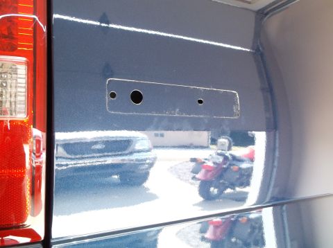 2005 Ford F-150 - A reflection shows a Ford F-150 truck and a motorcycle in the shiny surface of another vehicle.