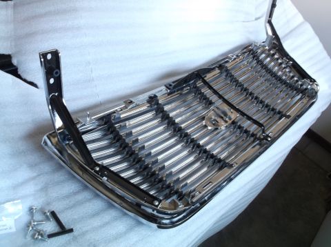 2005 Ford F-150 - A chrome grille with a distinctive pattern is shown, likely a replacement part for a vehicle.
