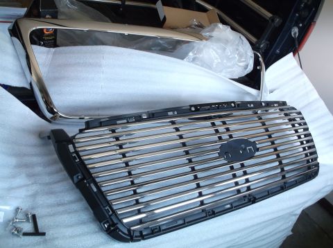 2005 Ford F-150 - Chrome grille and trim pieces are laid out, likely for installation on a truck.